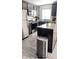 Kitchen featuring stainless steel appliances, granite counters, and wood grain floors at 1919 Escambia Ln, Kissimmee, FL 34759