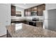 Modern kitchen boasts stainless steel appliances, granite countertops, and ample cabinet space at 1919 Escambia Ln, Kissimmee, FL 34759