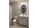 Modern bathroom featuring a decorative mirror, sink, vanity, and black and white tiled floors at 2019 Dixie Belle Dr # 2019L, Orlando, FL 32812