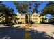 Condo building exterior with parking and trees on a sunny day at 2019 Dixie Belle Dr # 2019L, Orlando, FL 32812