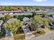 High-angle view of a home with lush landscaping and mature trees, located near commercial establishments at 2450 Parsons Pond Cir, Kissimmee, FL 34743