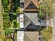 Overhead view of a home with a well-maintained roof, green lawn, and mature trees in a suburban setting at 2450 Parsons Pond Cir, Kissimmee, FL 34743