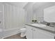 Bright bathroom with a tub and shower combination, featuring a modern vanity and neutral color palette at 2450 Parsons Pond Cir, Kissimmee, FL 34743