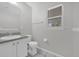 Well-lit bathroom with a contemporary vanity, a toilet, and a window, featuring a neutral color scheme at 2450 Parsons Pond Cir, Kissimmee, FL 34743