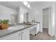 Spacious bathroom with dual sinks, a large mirror, and a separate shower, offering a luxurious feel at 2450 Parsons Pond Cir, Kissimmee, FL 34743