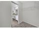 Walk-in closet with wire shelving leading to the vanity area at 2450 Parsons Pond Cir, Kissimmee, FL 34743