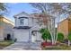 Charming two-story home with a well-maintained lawn and mature trees at 2450 Parsons Pond Cir, Kissimmee, FL 34743
