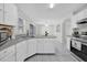 Bright kitchen with white cabinets, a breakfast bar, and open access to the living spaces at 2450 Parsons Pond Cir, Kissimmee, FL 34743