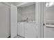 Efficient laundry room with a stacked washer and dryer for space-saving convenience at 2450 Parsons Pond Cir, Kissimmee, FL 34743