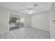 Neutral room with tile floors and sliding glass doors leading to a screened in porch at 2450 Parsons Pond Cir, Kissimmee, FL 34743