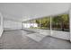 Bright sunroom with tiled flooring, a screened enclosure, and views of the backyard, perfect for relaxation at 2450 Parsons Pond Cir, Kissimmee, FL 34743