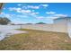 Spacious backyard featuring a well-maintained vinyl fence, creating a private and secure outdoor space at 251 Tower View W Dr, Haines City, FL 33844
