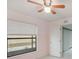 Bedroom featuring a ceiling fan, light pink accent wall, and a large window at 251 Tower View W Dr, Haines City, FL 33844