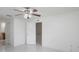Bright, open bedroom showcasing tiled floors, a ceiling fan, and an open door to an en suite at 251 Tower View W Dr, Haines City, FL 33844