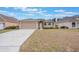 Inviting single-story home showcases a well-kept lawn, a spacious driveway and a two car attached garage at 251 Tower View W Dr, Haines City, FL 33844