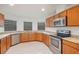 Bright kitchen features granite countertops, wooden cabinetry and stainless steel appliances at 251 Tower View W Dr, Haines City, FL 33844