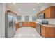 Spacious kitchen with stainless steel appliances, granite counters, and bright white tile flooring at 251 Tower View W Dr, Haines City, FL 33844
