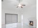 Bright living room featuring a fireplace, ceiling fan, and access to other rooms at 251 Tower View W Dr, Haines City, FL 33844