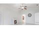 Living room showcases a fireplace, ceiling fan, and a view into the kitchen at 251 Tower View W Dr, Haines City, FL 33844