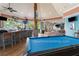 Inside view of the bar and billiards area with high-top seating, tables, and views of the pool at 313 Lucaya Loop # 313, Davenport, FL 33897