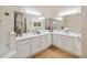 Spacious bathroom with dual sinks, a large vanity, and contemporary lighting fixtures at 313 Lucaya Loop # 313, Davenport, FL 33897