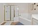 Well-lit bathroom featuring a shower, a tub, and tiled walls at 313 Lucaya Loop # 313, Davenport, FL 33897