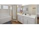 Bright bathroom with a double vanity, shower, and soaking tub at 313 Lucaya Loop # 313, Davenport, FL 33897