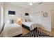 Bright bedroom featuring two beds, a patterned rug, and closet space at 313 Lucaya Loop # 313, Davenport, FL 33897