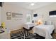 Charming bedroom featuring two beds, a modern rug, and bright decor at 313 Lucaya Loop # 313, Davenport, FL 33897