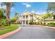 Attractive clubhouse with classic columns, balconies, and colorful landscaping at 313 Lucaya Loop # 313, Davenport, FL 33897