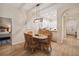 Charming dining area with a table, seating for six, modern lighting, and an open view to the kitchen at 313 Lucaya Loop # 313, Davenport, FL 33897