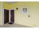 A ground floor condo entrance featuring a brown door and a small square window allowing for natural light at 313 Lucaya Loop # 313, Davenport, FL 33897