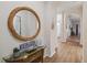Inviting hallway with decorative mirror, glass table and hardwood floors leading to other rooms in the condo at 313 Lucaya Loop # 313, Davenport, FL 33897