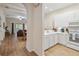 Bright condo kitchen with white cabinets, modern appliances, and an open layout flowing into the living area at 313 Lucaya Loop # 313, Davenport, FL 33897