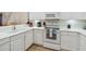 Bright condo kitchen with white cabinets, white countertops, and stainless steel appliances providing a modern aesthetic at 313 Lucaya Loop # 313, Davenport, FL 33897