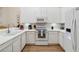 Well-lit condo kitchen with white cabinetry, white countertops, and stainless steel appliances providing a modern aesthetic at 313 Lucaya Loop # 313, Davenport, FL 33897