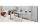 Condo kitchen with white cabinets, white countertops, and stainless steel appliances providing a modern aesthetic at 313 Lucaya Loop # 313, Davenport, FL 33897