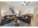 Cozy living room featuring two sofas, a glass-top coffee table, and an open floor plan to the kitchen at 313 Lucaya Loop # 313, Davenport, FL 33897
