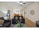 Bright living room with neutral walls, wood floors, comfortable seating, and an open view to the dining area at 313 Lucaya Loop # 313, Davenport, FL 33897