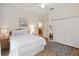 Sunlit main bedroom featuring a bed, closet, and modern décor at 313 Lucaya Loop # 313, Davenport, FL 33897