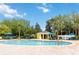 Community swimming pool with inviting blue water, ample lounge chairs, and a pool-side bathroom at 313 Lucaya Loop # 313, Davenport, FL 33897