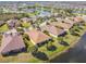 Overhead view of homes with screened lanais and lakefront views, set among mature trees in a well-planned community at 3390 Fallbrook Dr, Kissimmee, FL 34759
