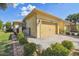 Well-maintained home featuring a paved driveway, a two-car garage, and lovely landscaping at 3390 Fallbrook Dr, Kissimmee, FL 34759