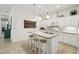 Well-lit kitchen showcasing white cabinetry and a practical island with seating at 3390 Fallbrook Dr, Kissimmee, FL 34759