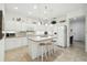 Bright kitchen featuring white cabinetry, mosaic backsplash, and an island with seating at 3390 Fallbrook Dr, Kissimmee, FL 34759