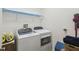 Laundry room equipped with a washer, dryer, and storage shelves for convenience at 3390 Fallbrook Dr, Kissimmee, FL 34759