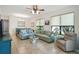 Cozy living room with large windows, comfortable seating, and a view into the dining area at 3390 Fallbrook Dr, Kissimmee, FL 34759