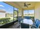 Relaxing screened patio with a ceiling fan and views of the beautiful lake at 3390 Fallbrook Dr, Kissimmee, FL 34759