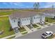 Spacious townhomes showcasing a well-kept exterior, individual driveways, and a beautifully landscaped community at 345 Sedgewick Dr, Davenport, FL 33837