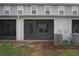 View of the home's back exterior with screened-in porch and air conditioning units in the yard at 345 Sedgewick Dr, Davenport, FL 33837